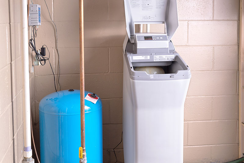 Water softener in the basement of a home.