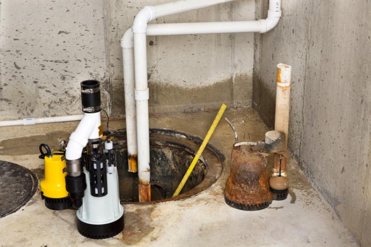 A sump pump in a basement being replaced.