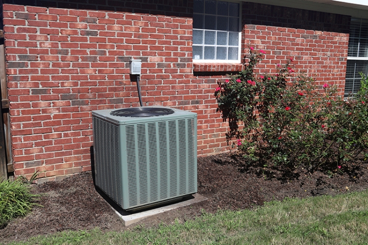 AC unit outside a brick house