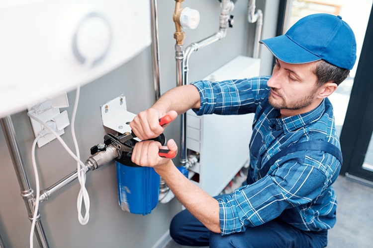 Technician installing water filtration system.