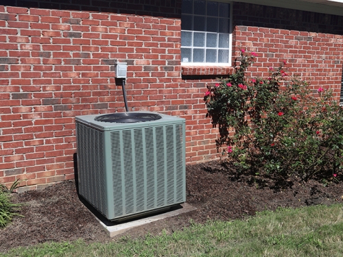 AC unit outside a brick house