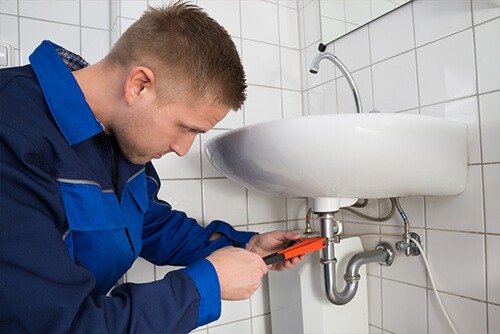 Plumber Repairing Sink