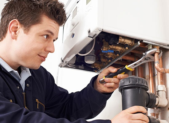 Technician repairing a faulty Boiler